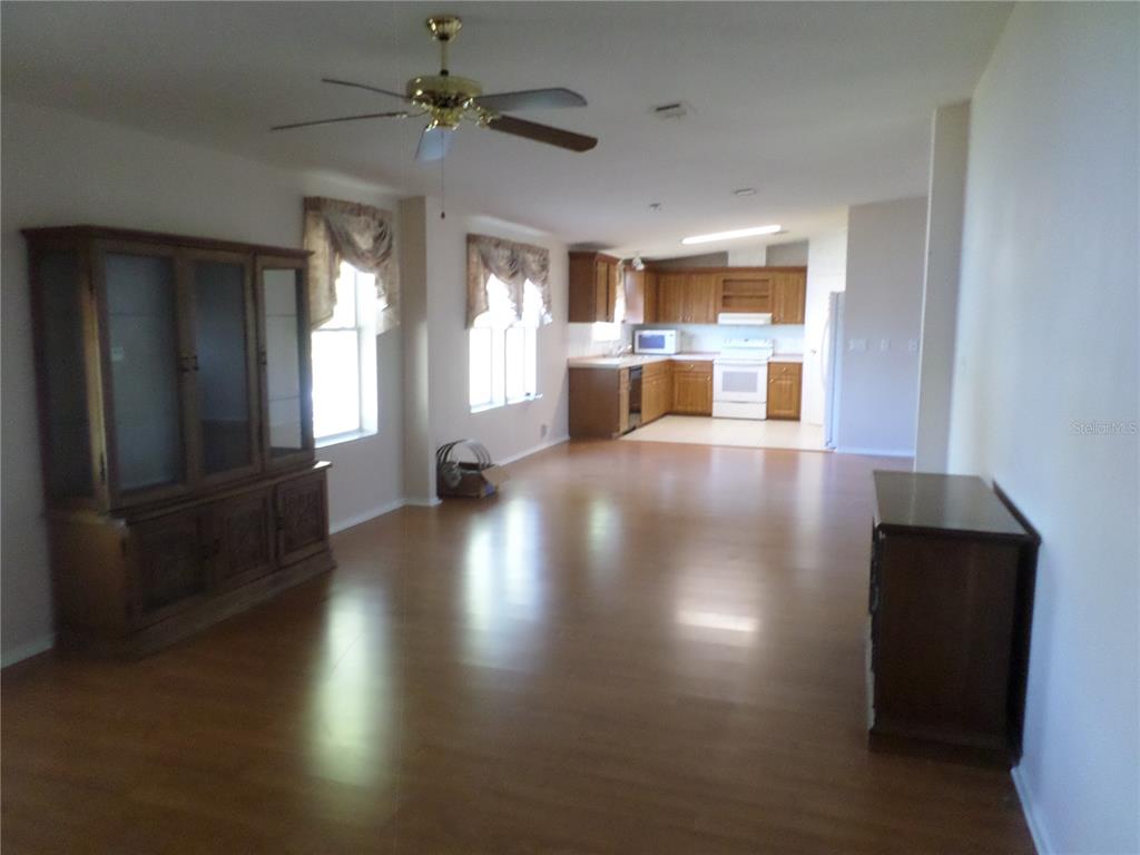 1690 Southwest 35th Circle Okeechobee, FL 34974 - Photo 13 of 23 a view of a living room and kitchen with hardwood floor