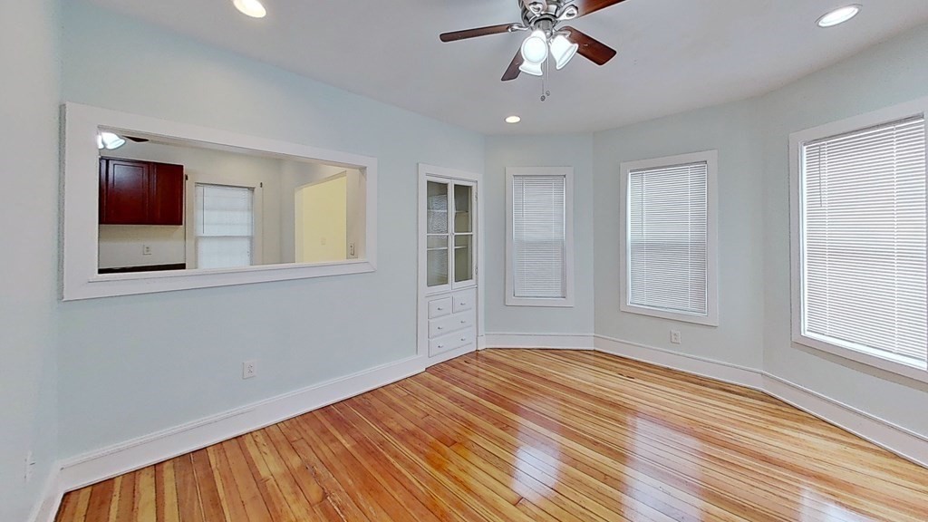 3 Dunlap Street Boston, MA 02124 - Photo 11 of 42 a view of an empty room with wooden floor and a window