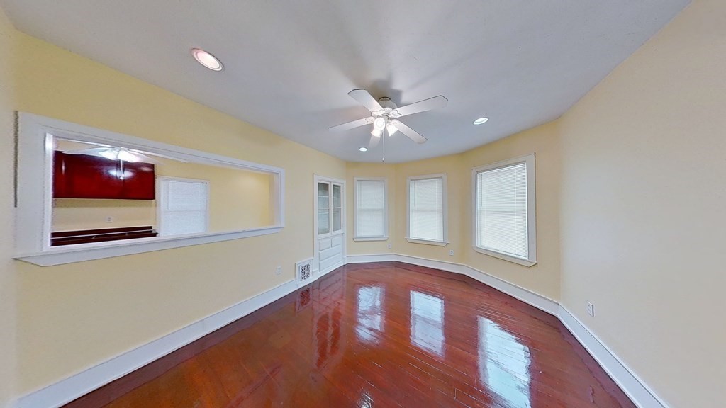 3 Dunlap Street Boston, MA 02124 - Photo 12 of 42 a view of an empty room with window and wooden floor