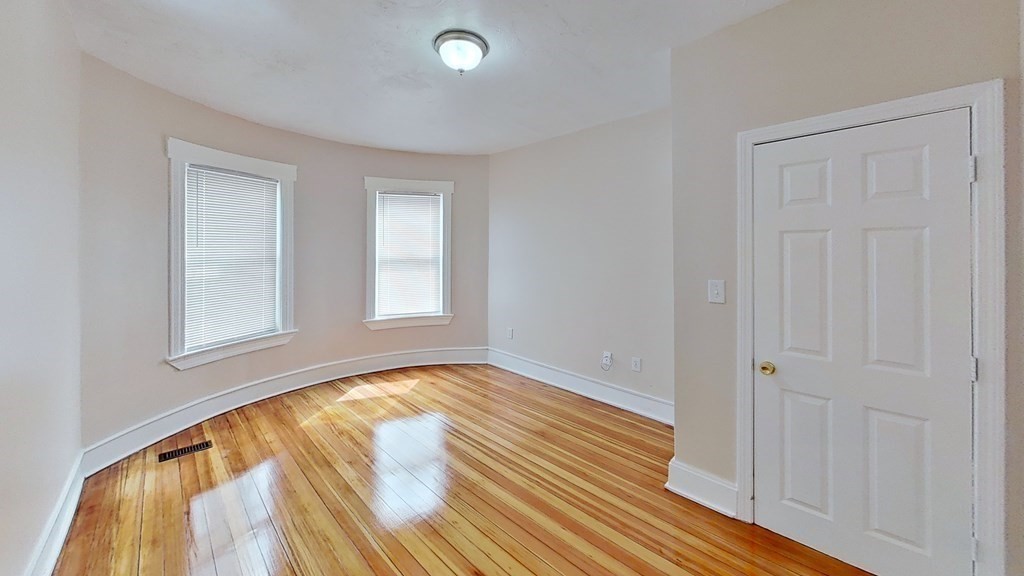3 Dunlap Street Boston, MA 02124 - Photo 16 of 42 wooden floor in an empty room with a window