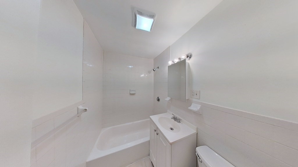 3 Dunlap Street Boston, MA 02124 - Photo 21 of 42 a bathroom with a bathtub sink vanity and toilet