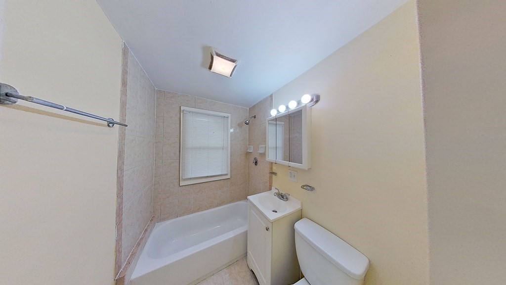 3 Dunlap Street Boston, MA 02124 - Photo 22 of 42 a bathroom with a toilet sink and mirror