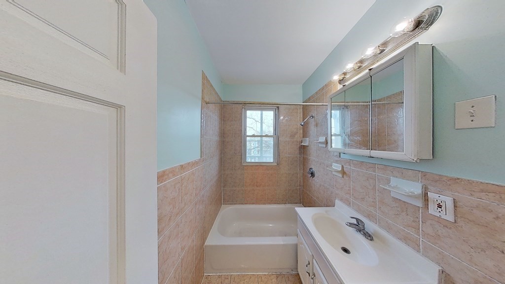 3 Dunlap Street Boston, MA 02124 - Photo 23 of 42 a bathroom with a tub sink and mirror