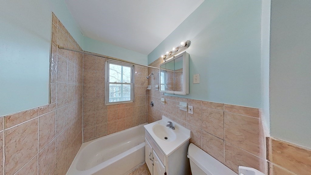 3 Dunlap Street Boston, MA 02124 - Photo 24 of 42 a bathroom with a bathtub sink and mirror