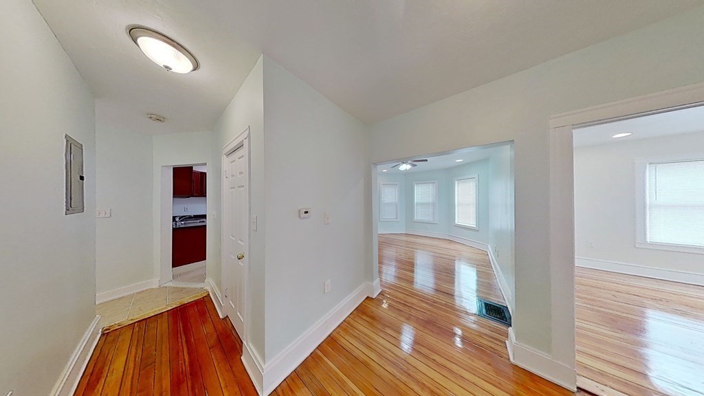 3 Dunlap Street Boston, MA 02124 - Photo 26 of 42 a view of a hallway with wooden floor and cabinet