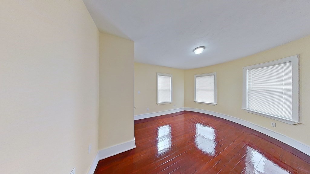 3 Dunlap Street Boston, MA 02124 - Photo 30 of 42 an empty room with wooden floor and windows