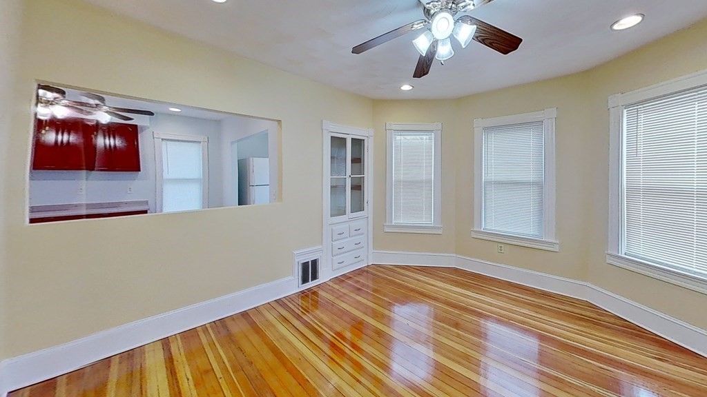 3 Dunlap Street Boston, MA 02124 - Photo 3 of 42 a bedroom with a bed and a chandelier