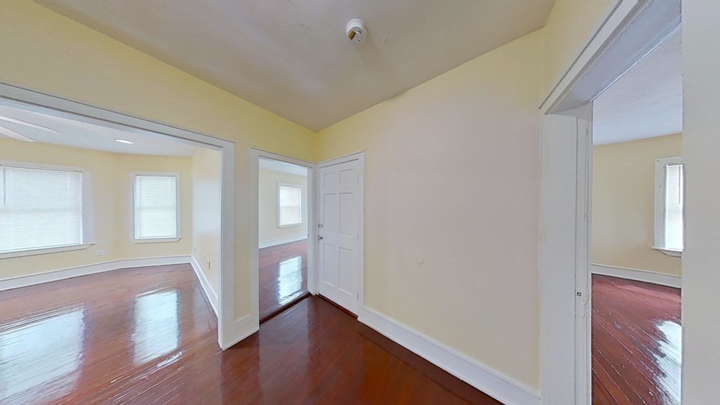 3 Dunlap Street Boston, MA 02124 - Photo 31 of 42 a view of an empty room with wooden floor and a window