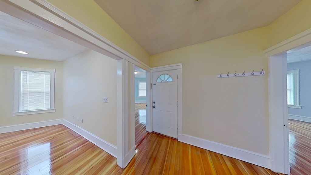 3 Dunlap Street Boston, MA 02124 - Photo 33 of 42 a view of a hallway with wooden floor and a bathroom