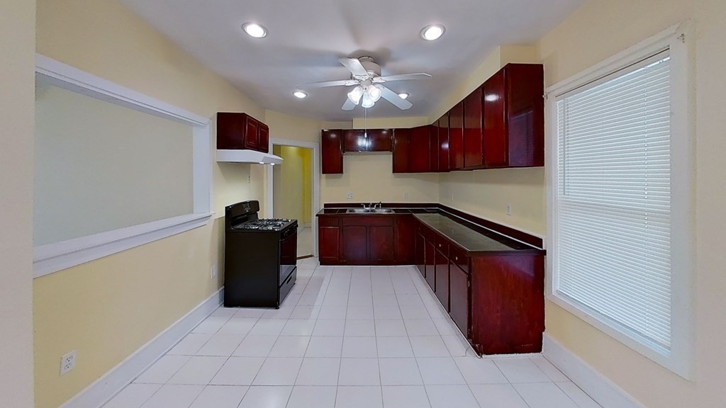 3 Dunlap Street Boston, MA 02124 - Photo 4 of 42 a kitchen with stainless steel appliances granite countertop a refrigerator a sink and dishwasher