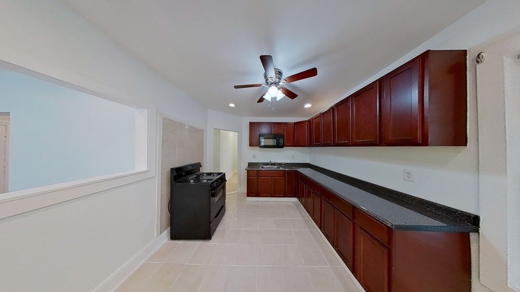 3 Dunlap Street Boston, MA 02124 - Photo 5 of 42 a kitchen with stainless steel appliances granite countertop a refrigerator and a sink