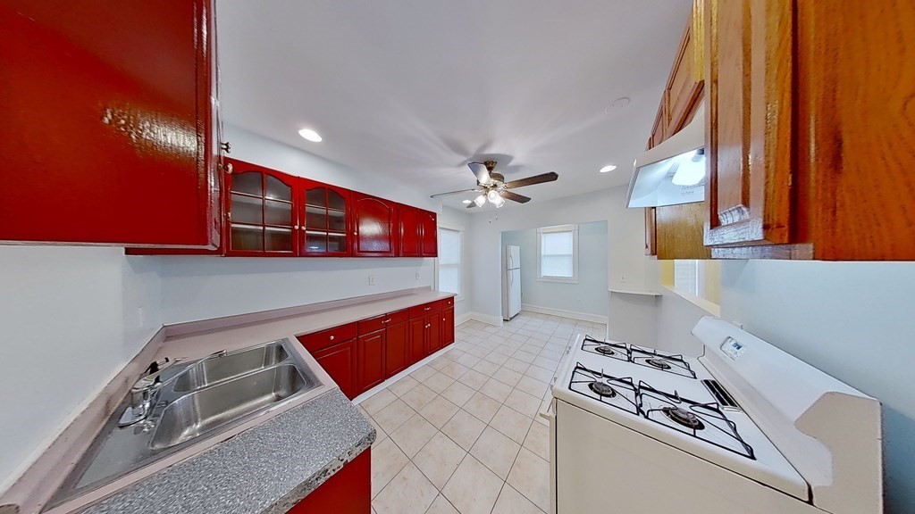 3 Dunlap Street Boston, MA 02124 - Photo 8 of 42 a kitchen with stainless steel appliances granite countertop a stove a sink and a microwave