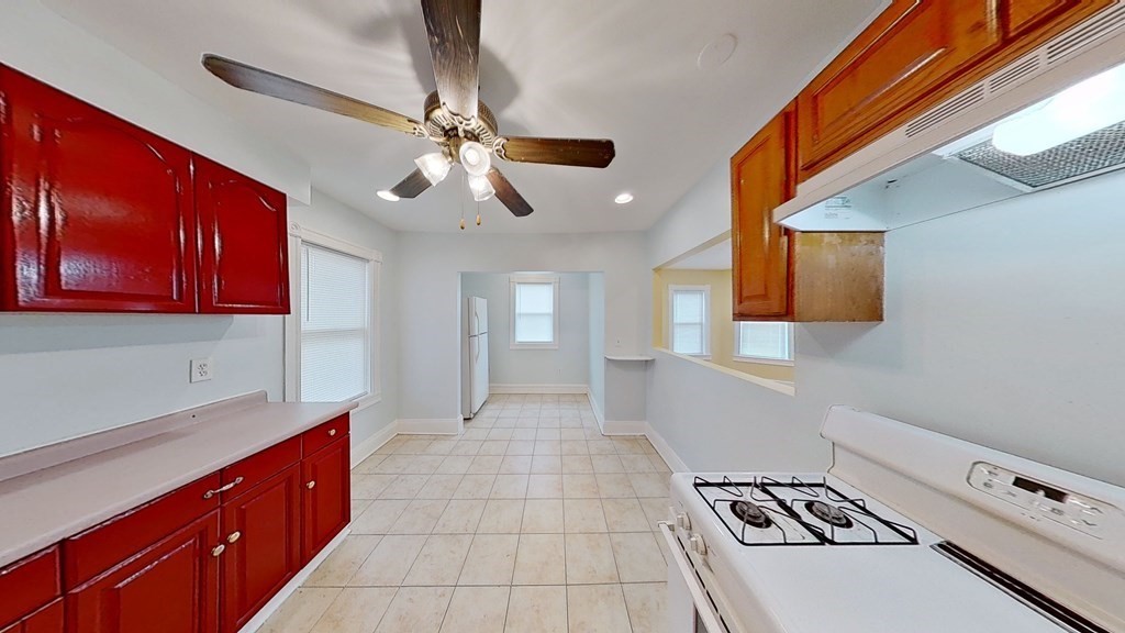 3 Dunlap Street Boston, MA 02124 - Photo 9 of 42 a kitchen with stainless steel appliances a stove a sink and a refrigerator
