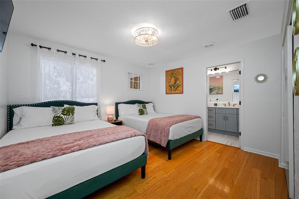 2153 Karan Way Clearwater, FL 33763 - Photo 26 of 65 a spacious bedroom with two beds and painted walls