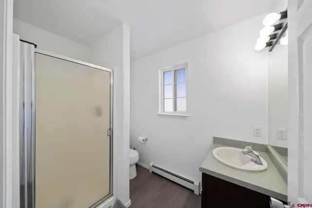 a bathroom with a sink toilet and a mirror
