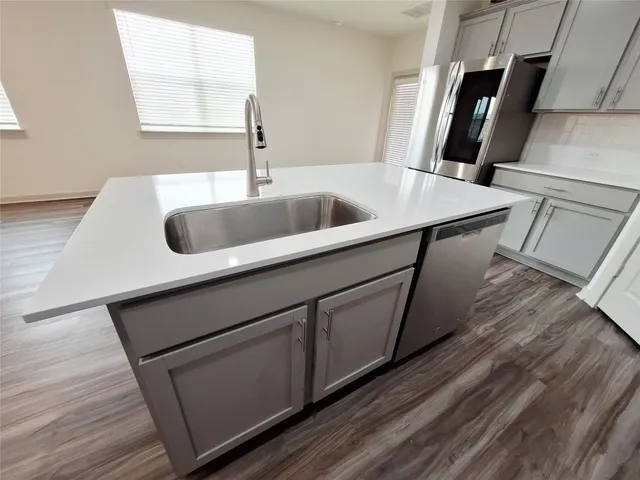 a bathroom with a double vanity sink a mirror and a shower