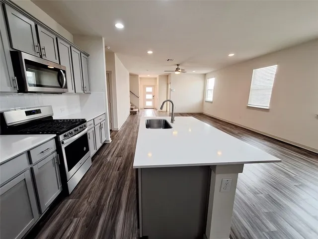 a bathroom with a shower a sink and a mirror