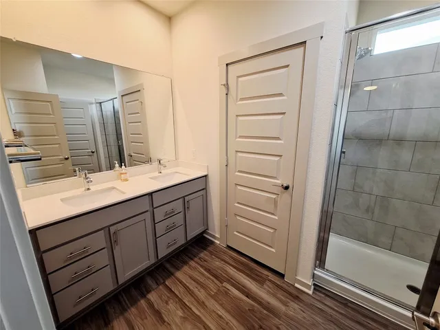 an empty room with a window and a kitchen