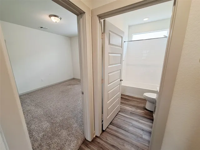 a view of a livingroom with a ceiling fan and window