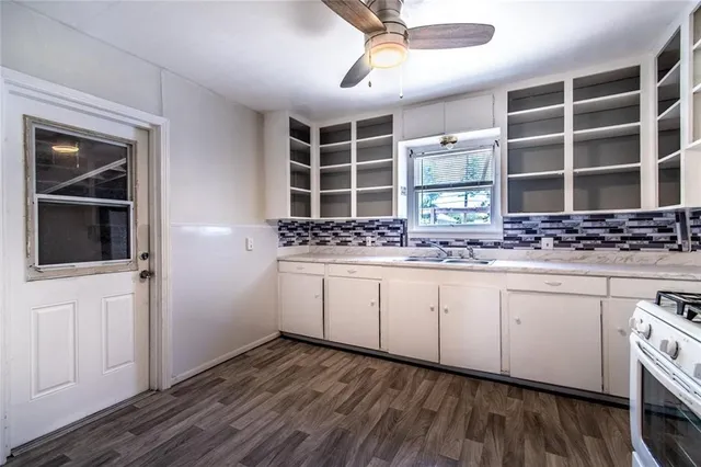 a view of cabinets with wooden floor and window