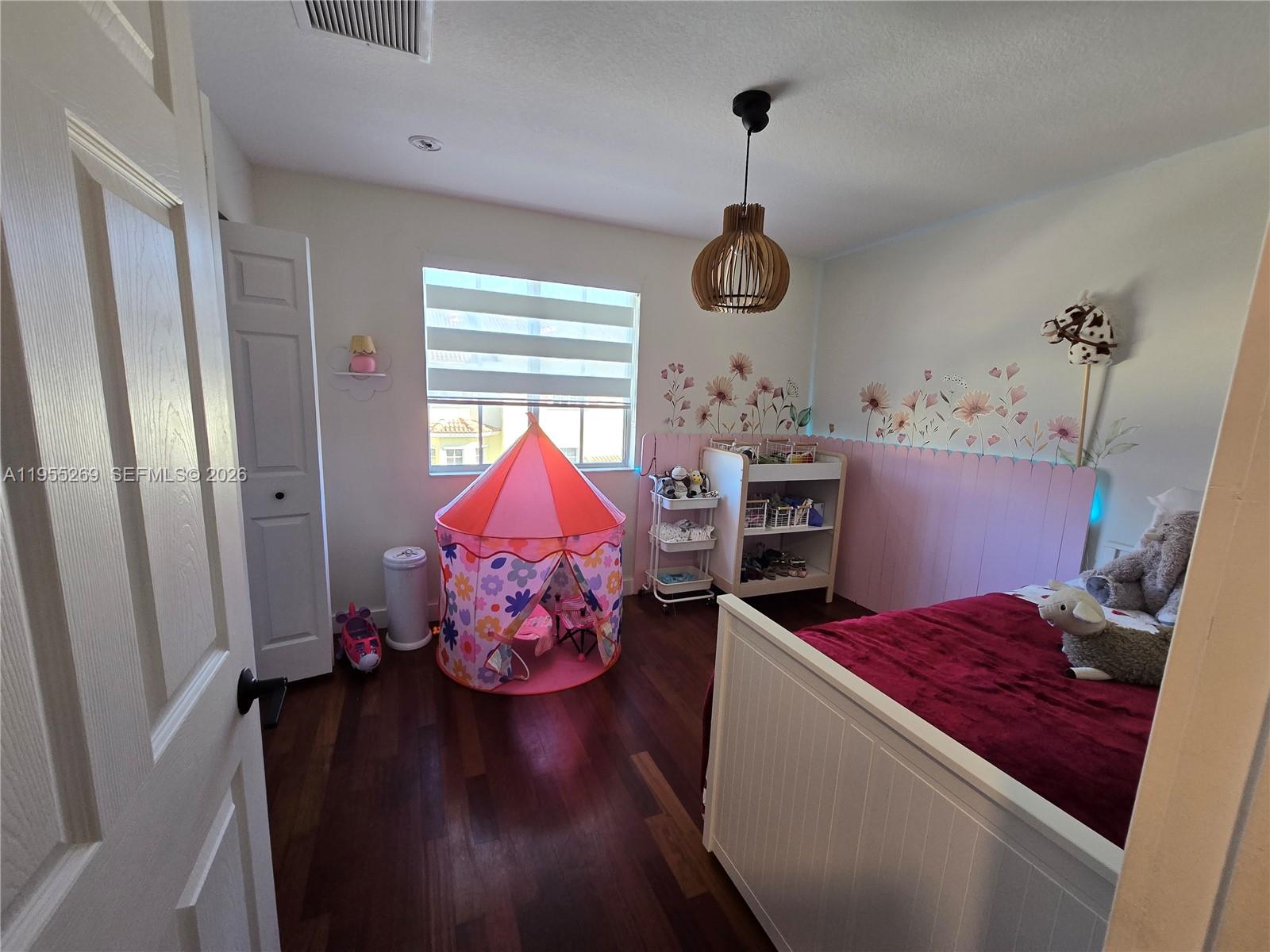738 Northeast 90th Street, Unit 207 Miami, FL 33138 - Photo 11 of 19 a bed room with a bed and a window