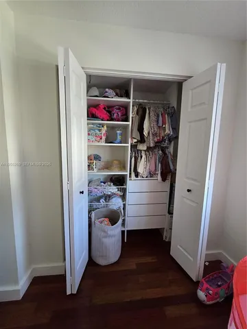 a view of an entryway with wooden floor