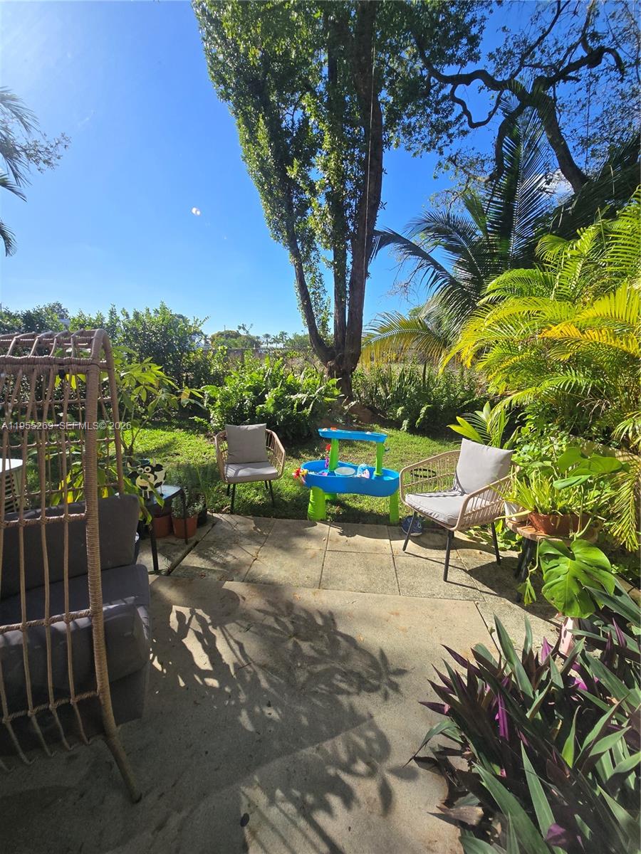 738 Northeast 90th Street, Unit 207 Miami, FL 33138 - Photo 16 of 19 a bench is sitting in the middle of a yard