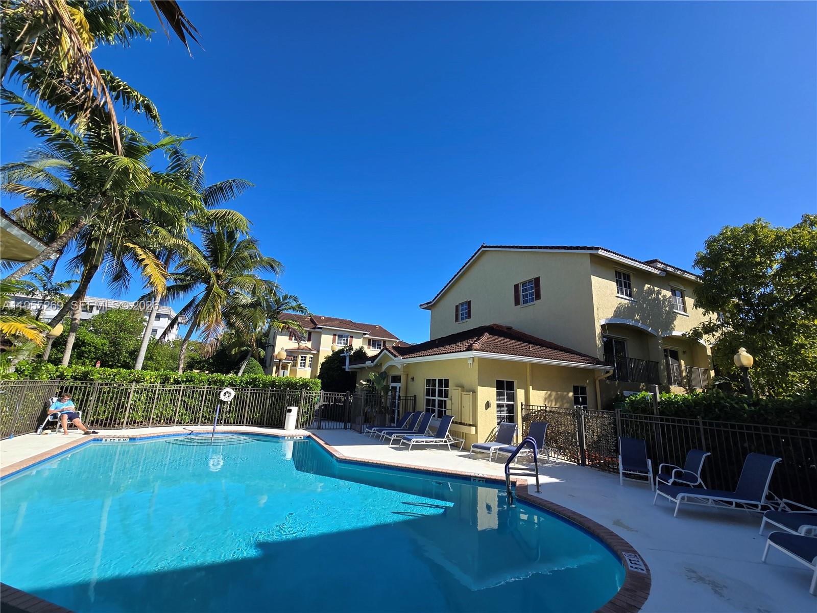 738 Northeast 90th Street, Unit 207 Miami, FL 33138 - Photo 17 of 19 a table and chairs in front of a building