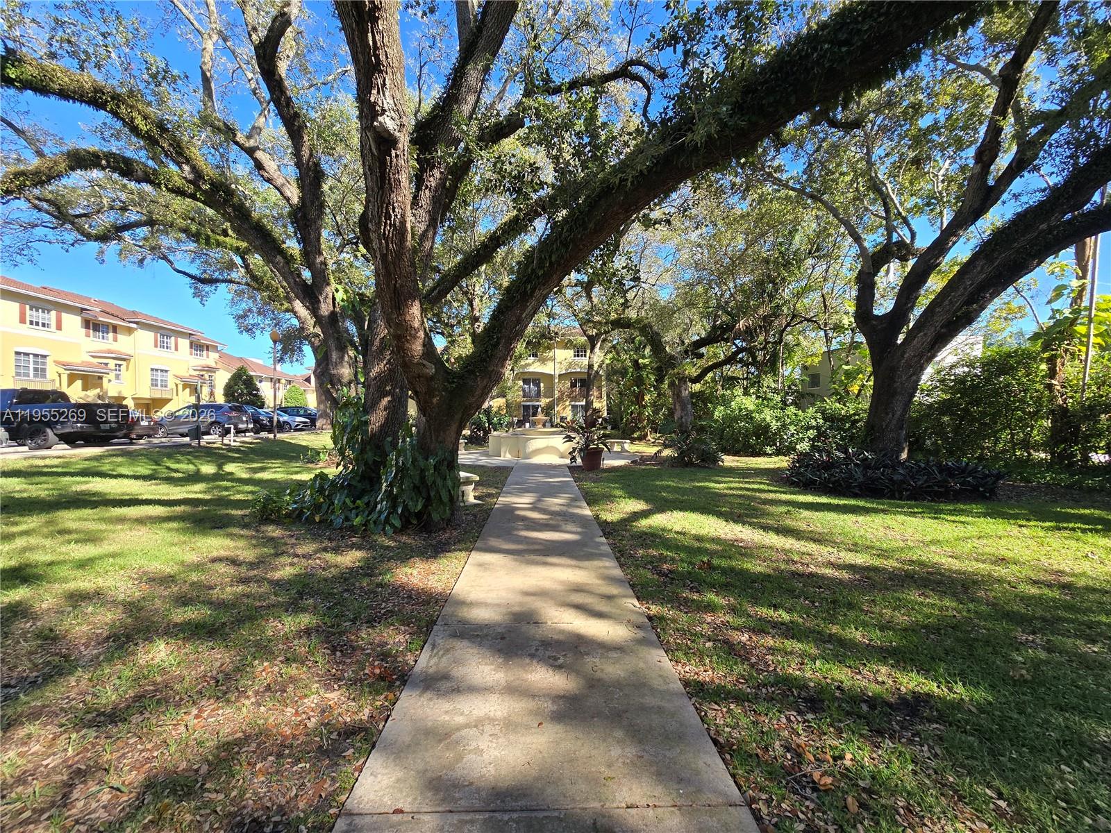 738 Northeast 90th Street, Unit 207 Miami, FL 33138 - Photo 18 of 19 a view of a park with large trees