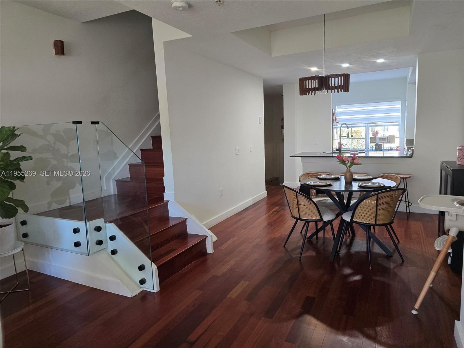 738 Northeast 90th Street, Unit 207 Miami, FL 33138 - Photo 2 of 19 a view of a room with furniture and wooden floor