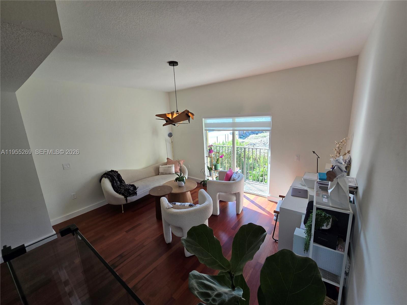738 Northeast 90th Street, Unit 207 Miami, FL 33138 - Photo 3 of 19 a living room with furniture and a window