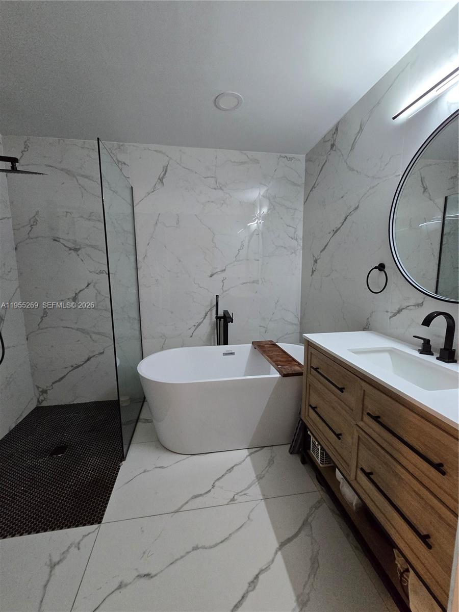 738 Northeast 90th Street, Unit 207 Miami, FL 33138 - Photo 9 of 19 a bathroom with a bathtub sink and toilet