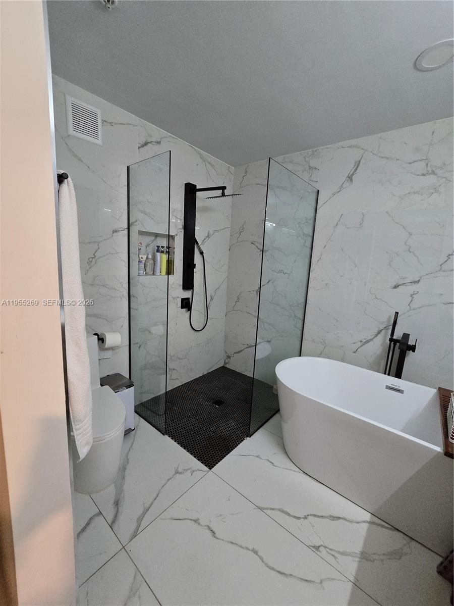 738 Northeast 90th Street, Unit 207 Miami, FL 33138 - Photo 10 of 19 a bathroom with a sink a toilet and shower