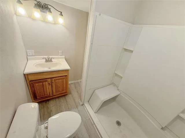 a bathroom with a sink a toilet and mirror