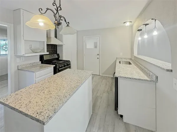 a kitchen with a sink a stove and refrigerator