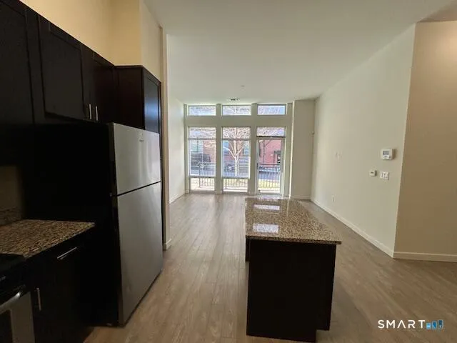 a kitchen with a refrigerator and a stove top oven