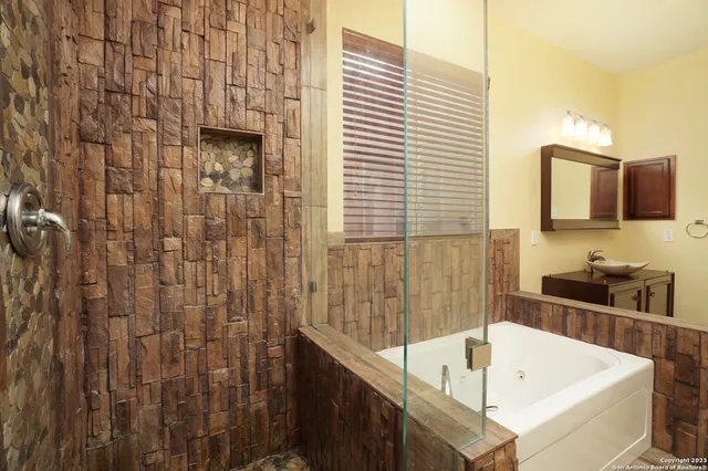 a bathroom with a tub and a sink