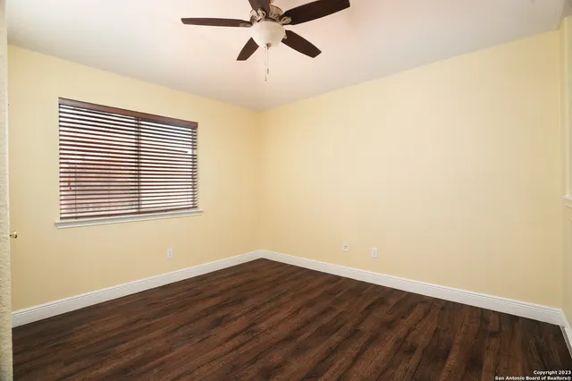 a view of a room with wooden floor and a window