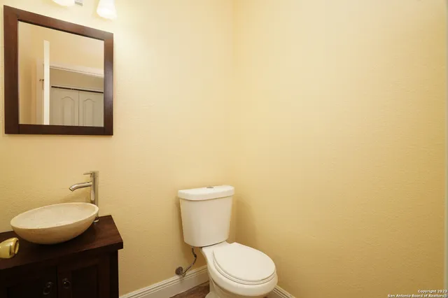 a white toilet sitting next to a bathroom sink