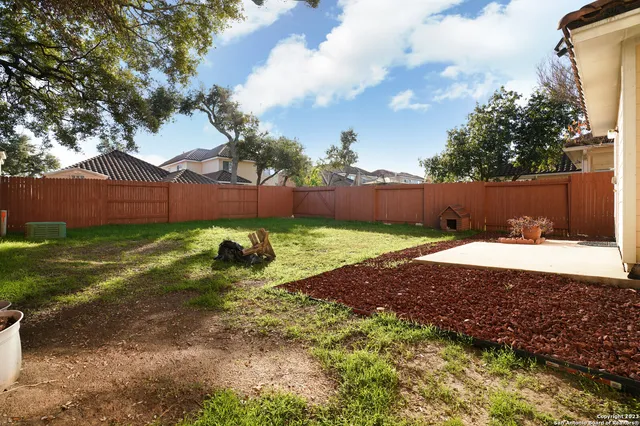 a view of a house with a yard and sitting area