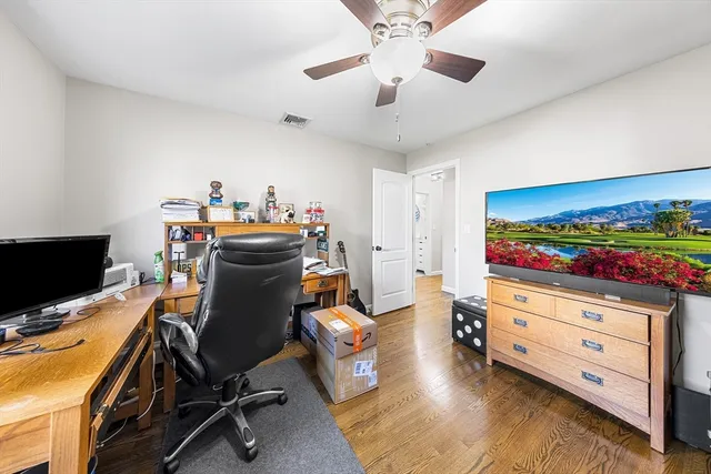 a view of a workspace with furniture and a flat screen tv