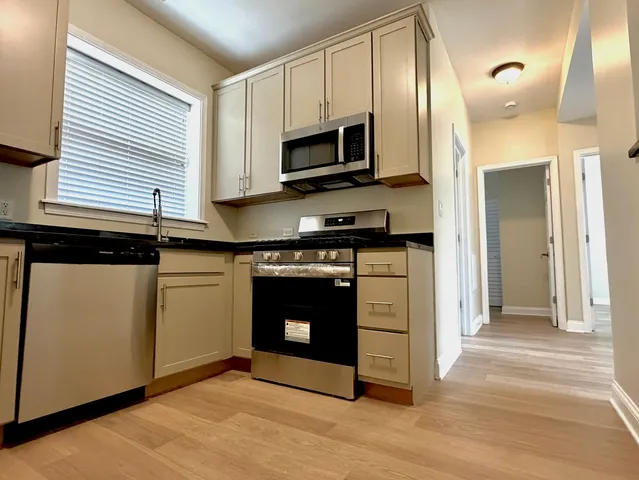 a kitchen with a stove and a microwave