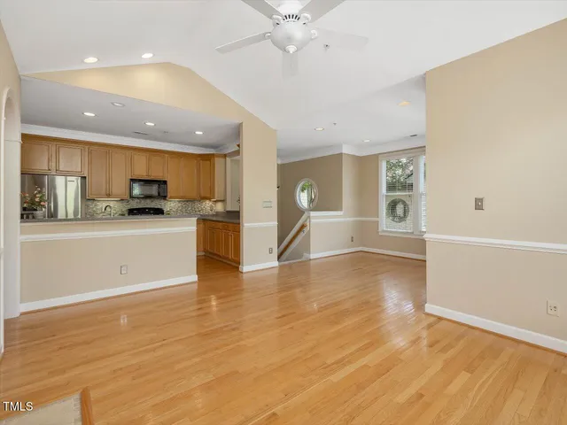 a view of a kitchen with wooden floor and a kitchen