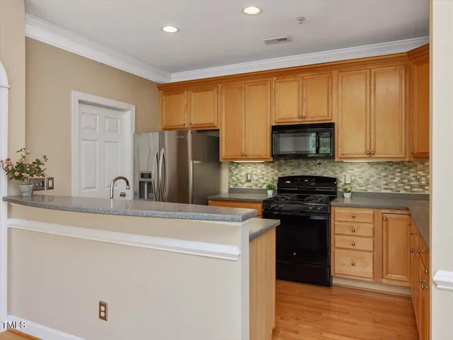 a kitchen with stainless steel appliances a stove microwave and refrigerator