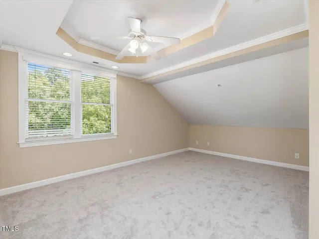 en empty room with windows and chandelier fan