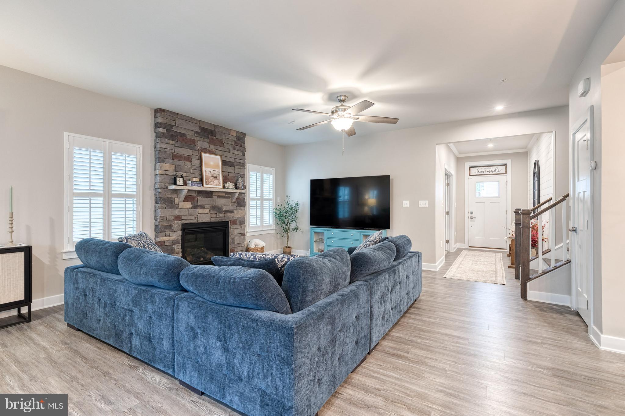 6003 Valentine Way Hanover, MD 21076 - Photo 9 of 52 a living room with furniture a flat screen tv and a fireplace