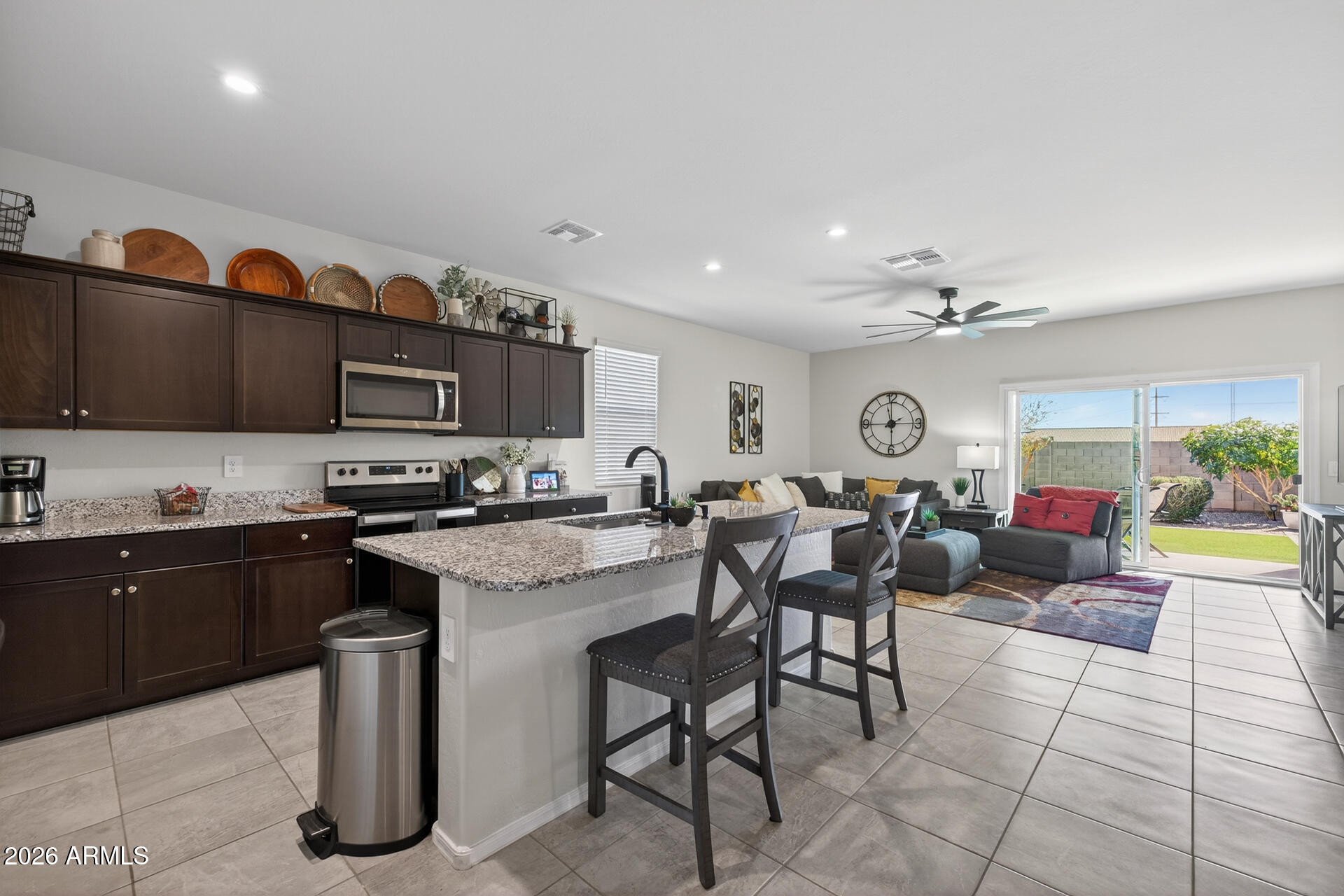 9573 Cotton Road Florence, AZ 85132 - Photo 12 of 46 a open kitchen with stainless steel appliances granite countertop a stove and a sink
