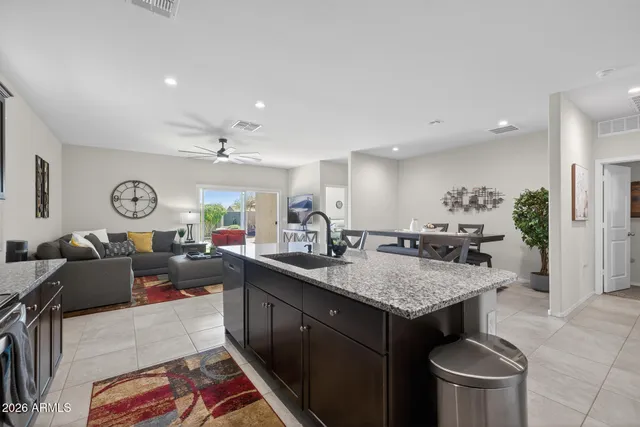 a open kitchen with stainless steel appliances granite countertop a stove and a sink
