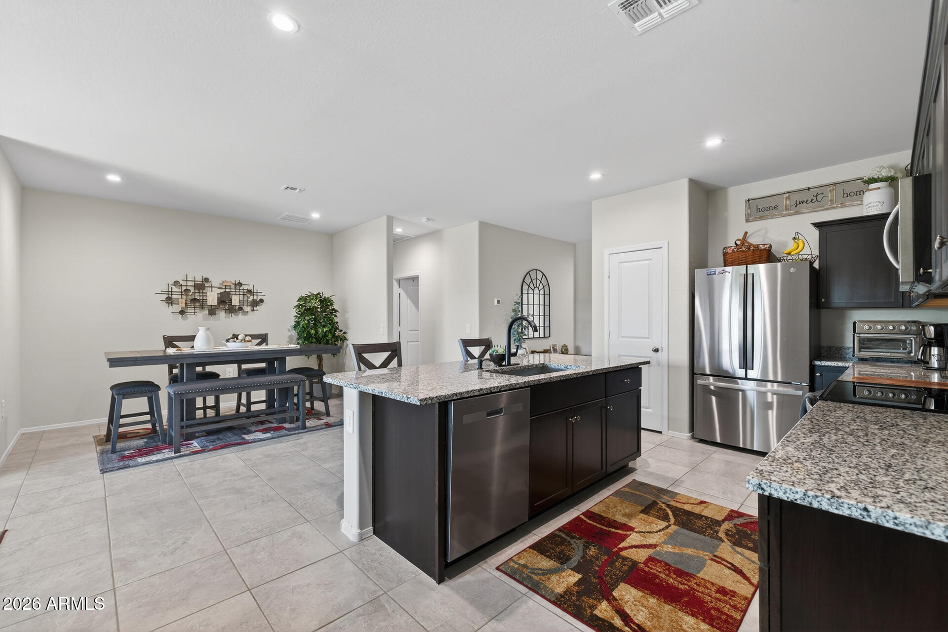 9573 Cotton Road Florence, AZ 85132 - Photo 14 of 46 a kitchen with stainless steel appliances granite countertop a sink and a refrigerator