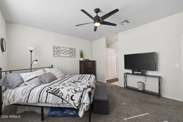 a bedroom with a bed and a dresser